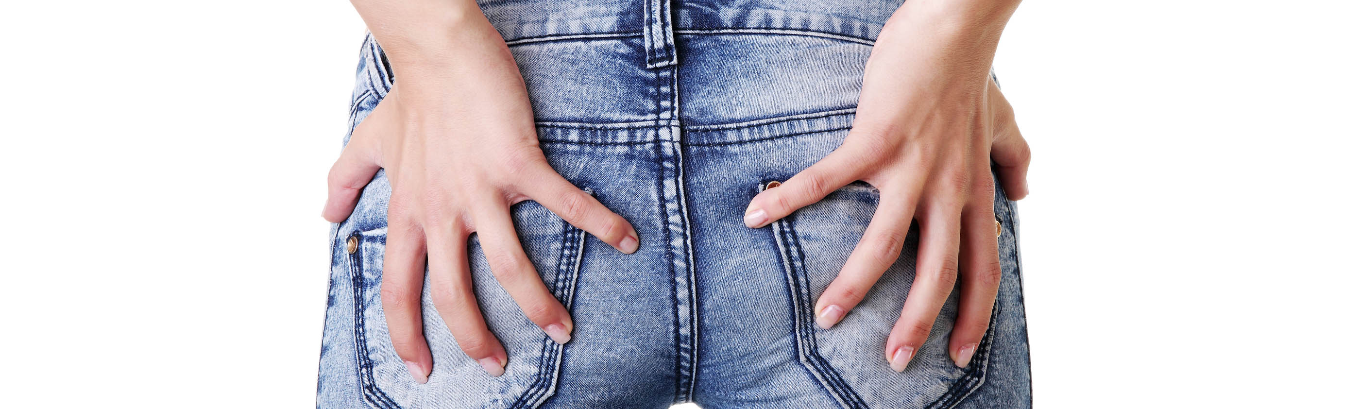 Girl in jeans holding bum - possible hemorrhoids