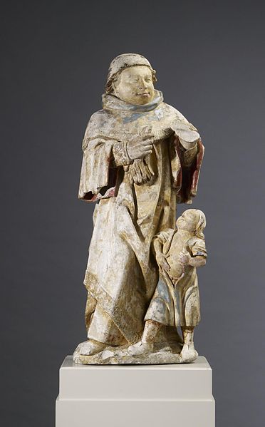 Saint Cosmas, gloves in hand, heals a man with a bloated stomach-statue